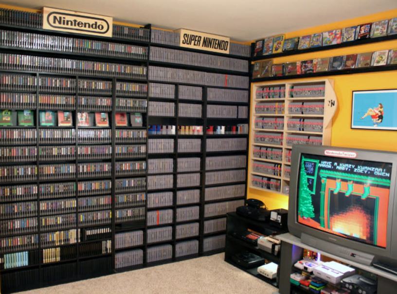 A video game room with shelves of video games.