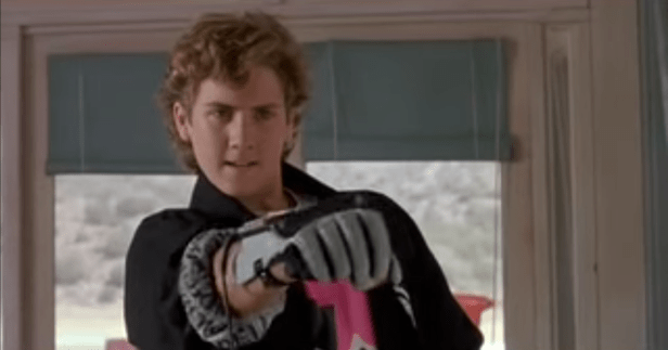 Kid playing a video game using the Power Glove.